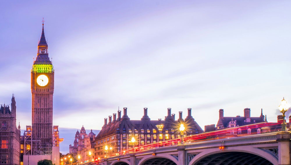 London's Big Ben at the end of a bridge in twilight