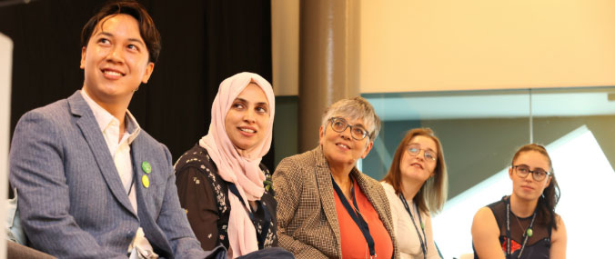 One gentlemen and four ladies looking to the left direction and smiling.