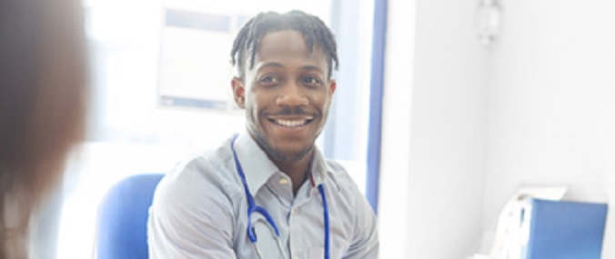 An image of a smiling medical practitioner in conversation.