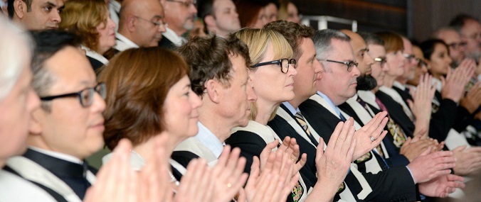 An audience applauding at a ceremonial event