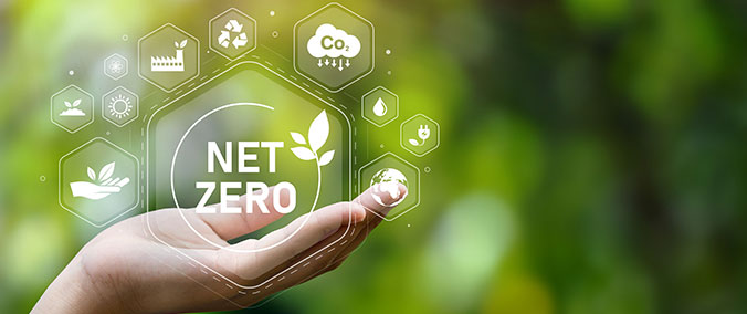 Net zero image surrounded by green energy symbols.