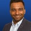 Headshot of Dr Thuva Amuthalingam smiling.